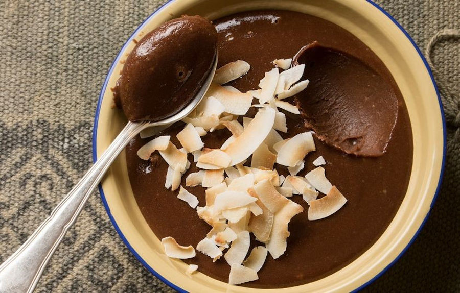 close-up of bowl with chocolate mousse with slices of almonds on top and a teaspoon at 'M. Kosmidis'